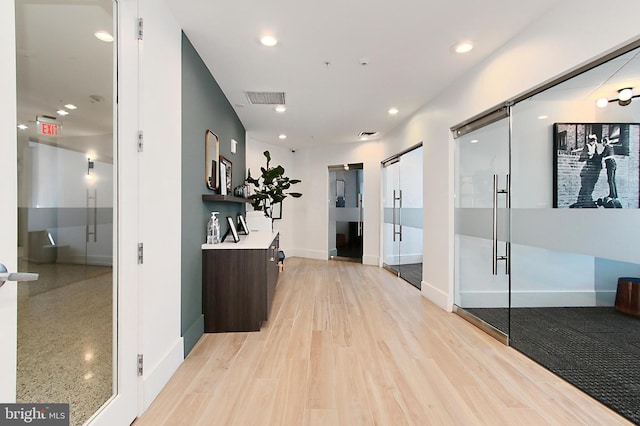 corridor featuring recessed lighting, visible vents, and light wood finished floors