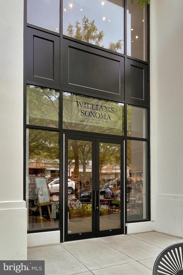 entrance to property featuring french doors and stucco siding