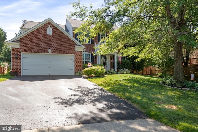 view of front of home featuring brick siding, driveway, an attached garage, and a front lawn