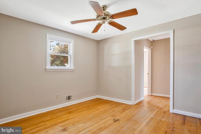 unfurnished room featuring visible vents, baseboards, a ceiling fan, and light wood finished floors