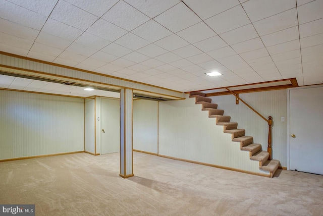 finished basement featuring carpet and stairs