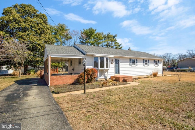 ranch-style house featuring brick siding and a front yard