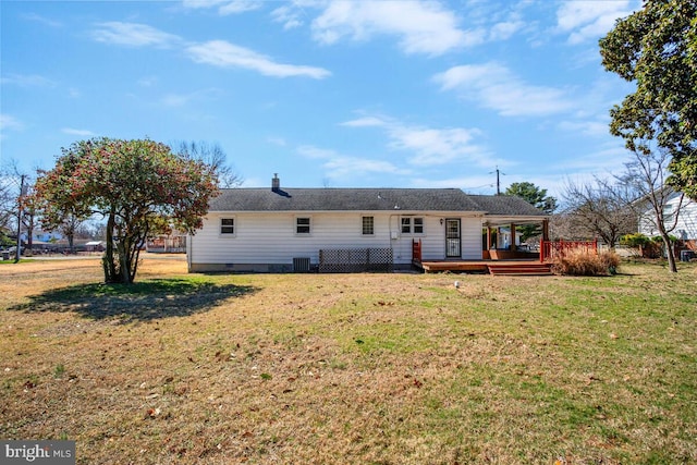 back of house featuring a lawn, central AC, and a wooden deck