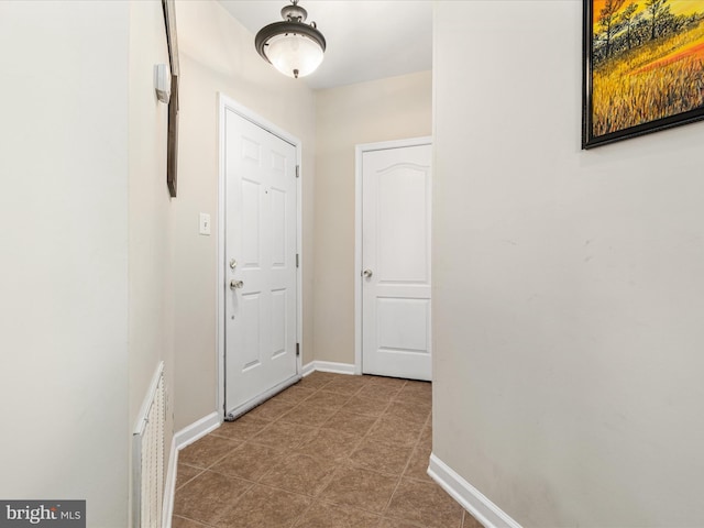 hallway featuring visible vents and baseboards