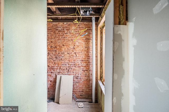 interior space featuring brick wall