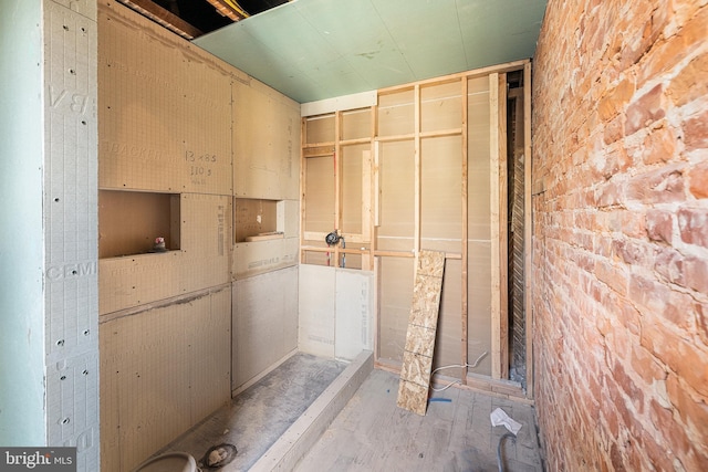 bathroom with brick wall