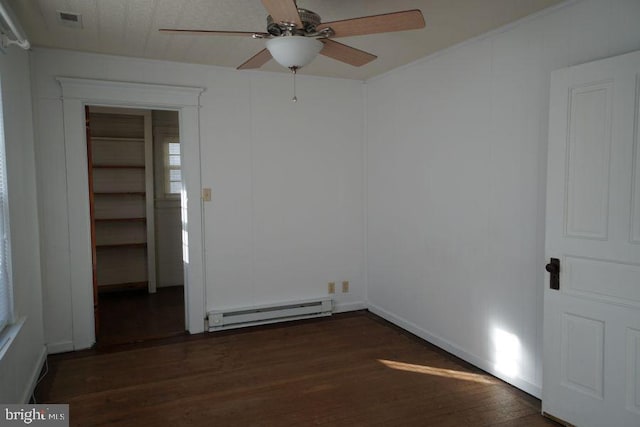 unfurnished room featuring baseboard heating, ceiling fan, dark wood-type flooring, and visible vents