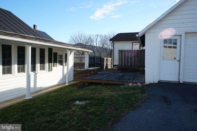 view of yard featuring a deck and fence