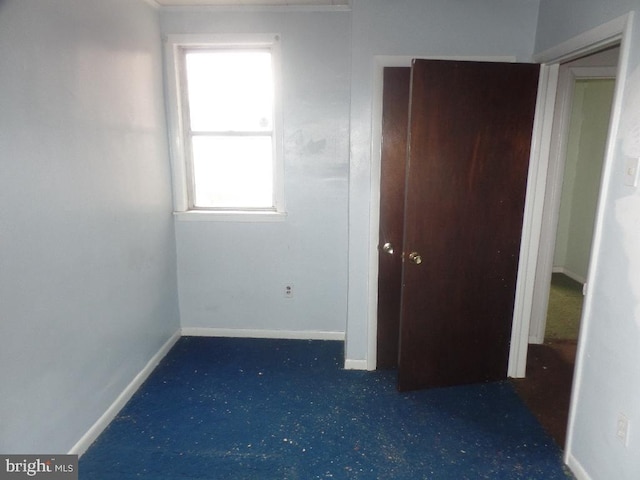 unfurnished bedroom with baseboards and carpet floors