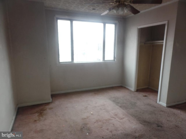 unfurnished bedroom featuring a closet, carpet, and baseboards