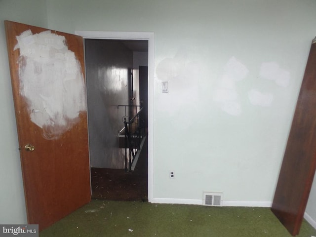 unfurnished room featuring visible vents and baseboards