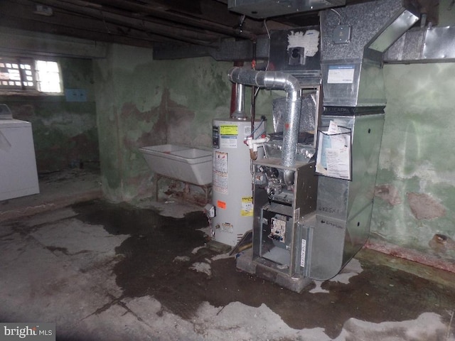 utility room featuring heating unit, gas water heater, washer / clothes dryer, and a sink