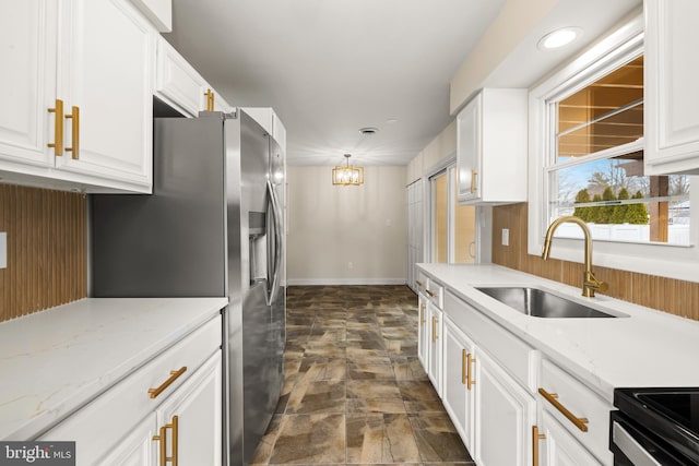 kitchen featuring a sink, white cabinets, and stainless steel refrigerator with ice dispenser