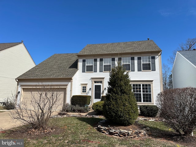 colonial home with a garage, roof with shingles, and driveway