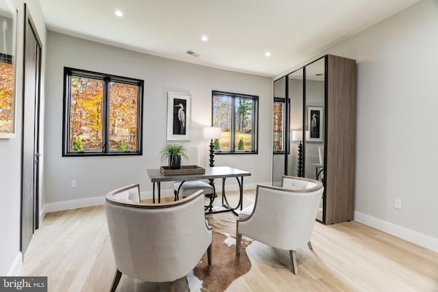 office space featuring recessed lighting, light wood-style flooring, and baseboards