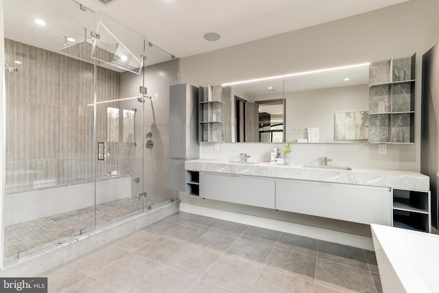 bathroom with tile patterned flooring, recessed lighting, a shower stall, and double vanity