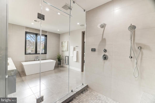 full bathroom with visible vents, a soaking tub, recessed lighting, a shower stall, and tile patterned floors