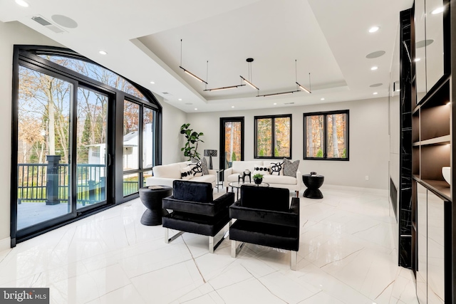 interior space featuring visible vents, a raised ceiling, marble finish floor, recessed lighting, and baseboards