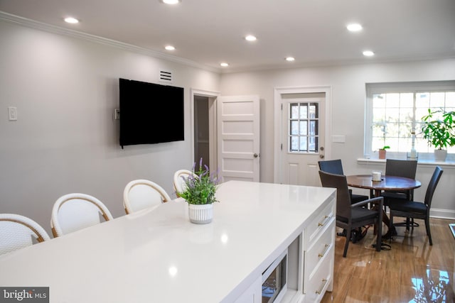 kitchen featuring crown molding, light countertops, recessed lighting, light wood-style flooring, and white cabinets