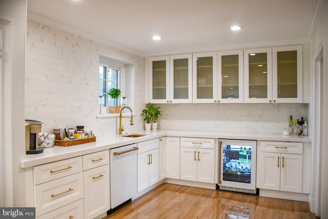 bar featuring a sink, wine cooler, light wood-style floors, dishwasher, and backsplash