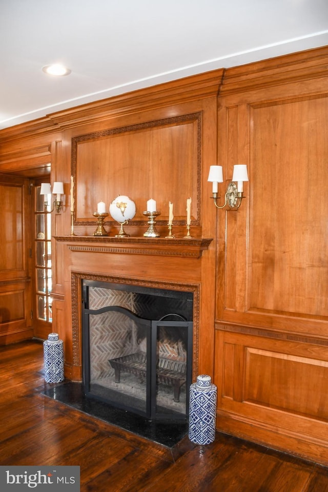 room details with a fireplace with flush hearth and wood finished floors