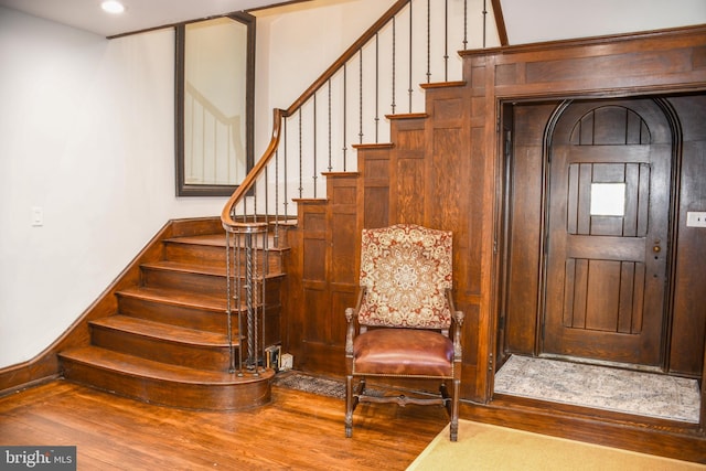 stairway with baseboards and wood finished floors