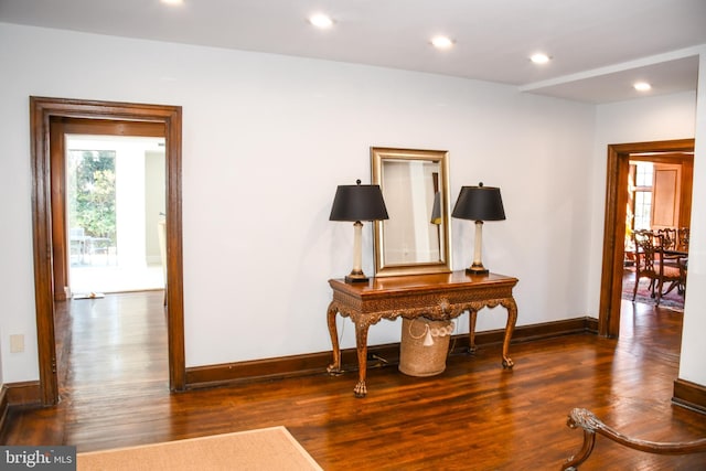 interior space with recessed lighting, wood finished floors, and baseboards