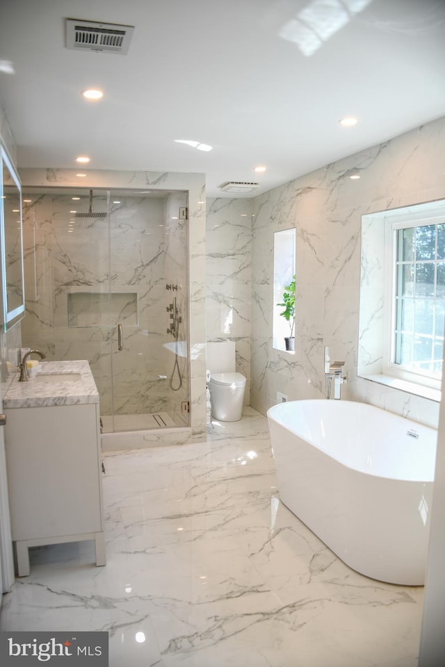 full bathroom with visible vents, stone wall, and a healthy amount of sunlight