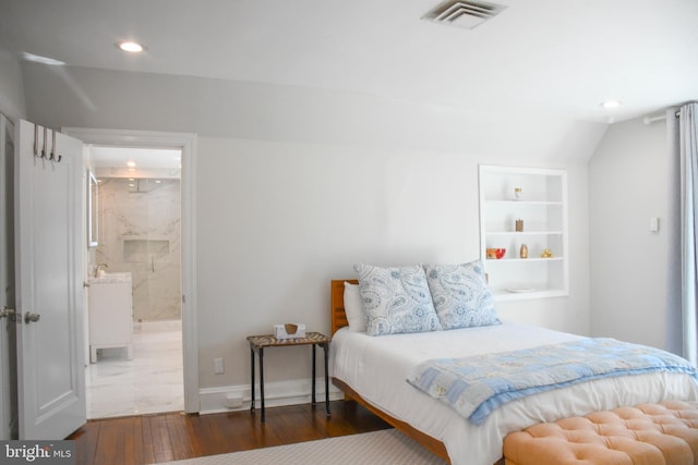 bedroom with visible vents, ensuite bath, wood finished floors, recessed lighting, and baseboards