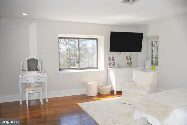 bedroom with recessed lighting, visible vents, baseboards, and wood finished floors