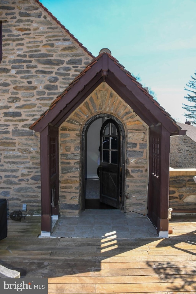 entrance to property with stone siding