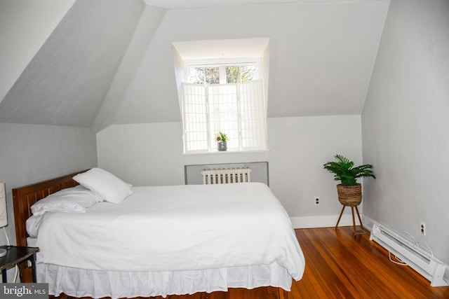 bedroom featuring wood finished floors, baseboards, radiator heating unit, vaulted ceiling, and a baseboard heating unit