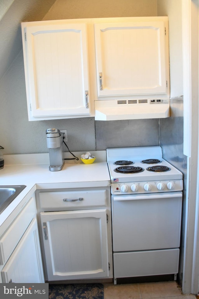 kitchen featuring white range with electric cooktop, white cabinets, light countertops, and under cabinet range hood