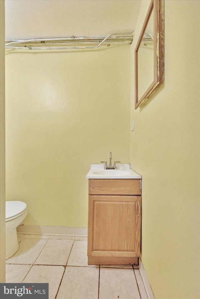 bathroom featuring vanity, toilet, and tile patterned flooring