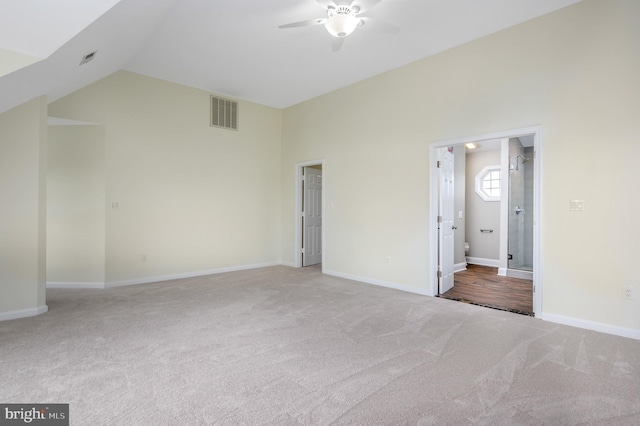 unfurnished bedroom featuring baseboards, carpet, lofted ceiling, and visible vents