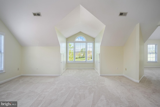 bonus room featuring visible vents, carpet floors, and vaulted ceiling