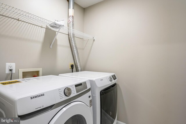 clothes washing area with laundry area and washing machine and clothes dryer