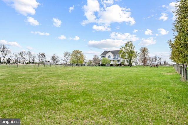 view of yard featuring fence and a rural view