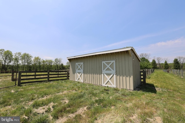 view of outbuilding featuring fence and an outdoor structure