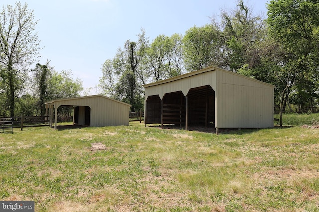 view of pole building featuring fence and a detached carport