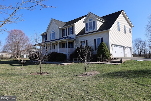 view of front of house with covered porch, an attached garage, concrete driveway, and a front yard