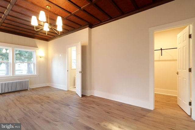 unfurnished room with radiator, baseboards, wood ceiling, light wood-type flooring, and an inviting chandelier