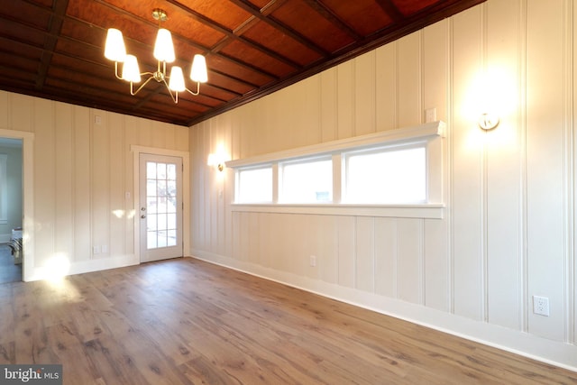 unfurnished room featuring wood ceiling, an inviting chandelier, and wood finished floors