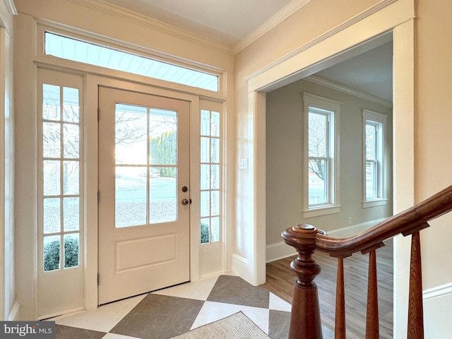 doorway with crown molding, stairway, and baseboards