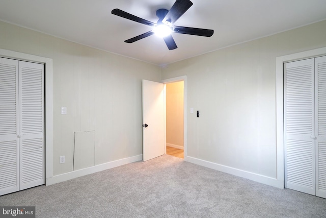 unfurnished bedroom featuring carpet flooring, a ceiling fan, and baseboards