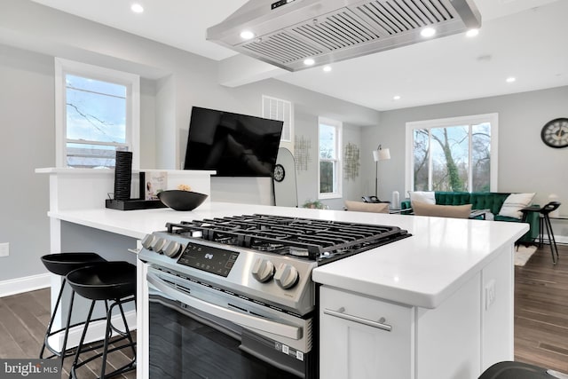 kitchen featuring recessed lighting, gas stove, dark wood-type flooring, and custom range hood