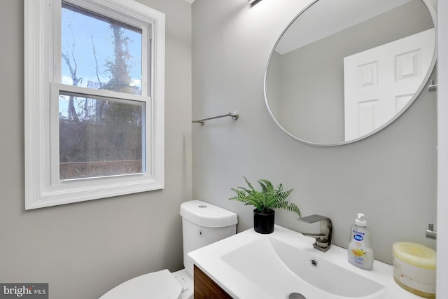 bathroom featuring toilet and vanity