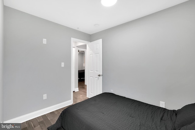 bedroom with wood finished floors and baseboards