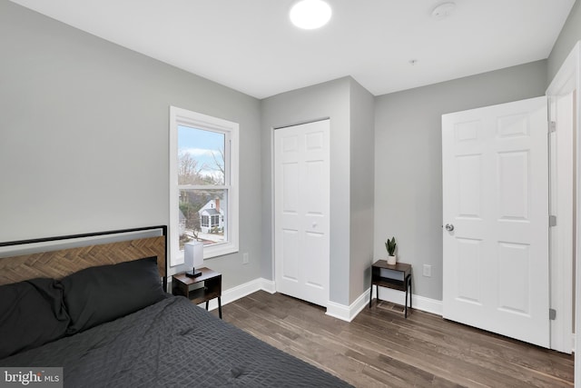 bedroom with baseboards and dark wood finished floors