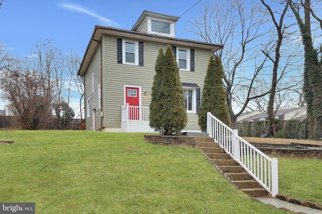 traditional style home with a front yard and fence